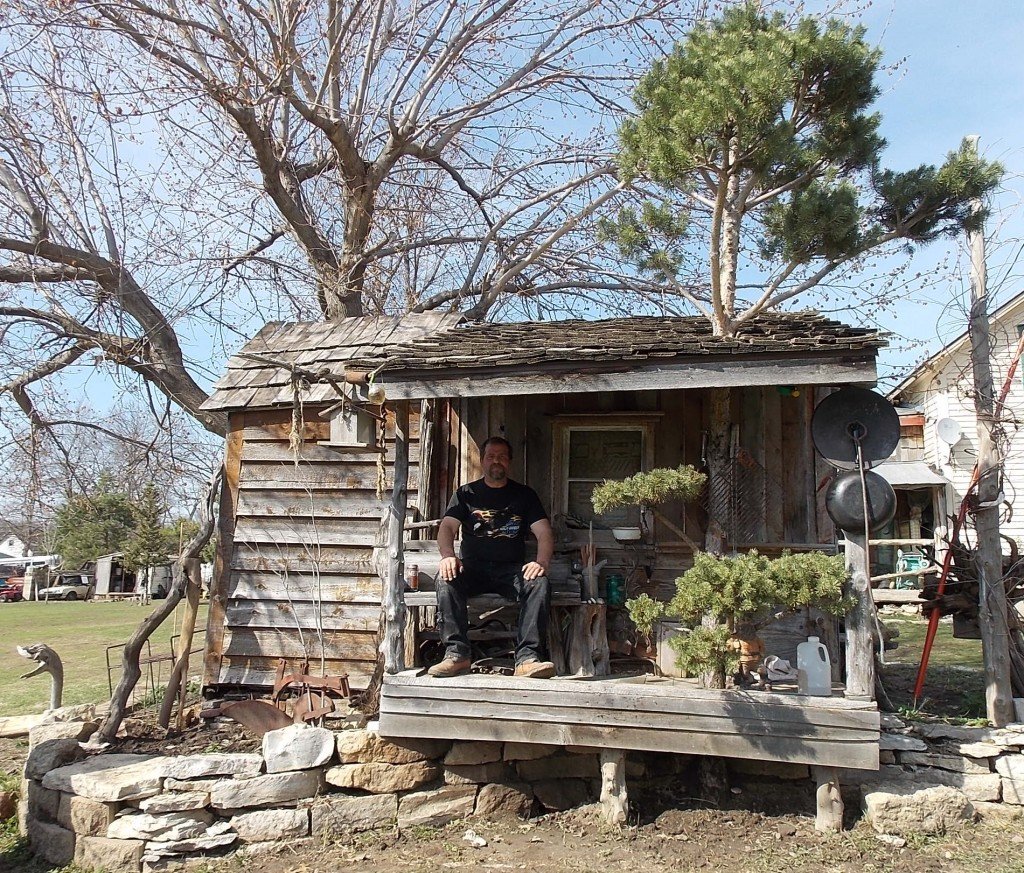 andy in back of outhouse